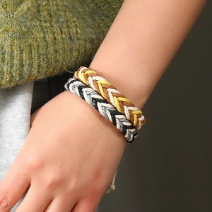 Detail of hand-woven cotton rope couple bracelets in bohemian braided fishbone style