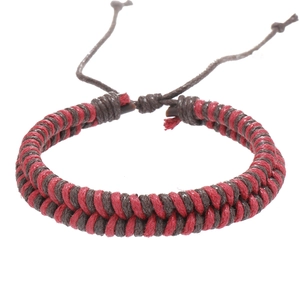 Detail of red and brown handmade braided wax rope bracelet with adjustable sliding knot