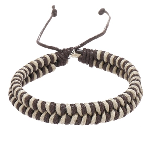 Macro detail of hand-woven dual-strand cord bracelet with adjustable sliding knot closure