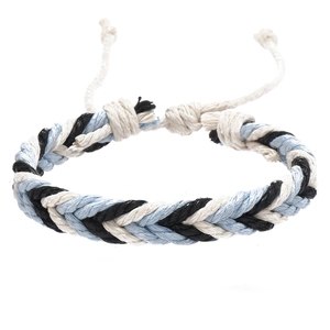 Close-up of tricolor braided cotton bracelet with adjustable knotted sliding closure