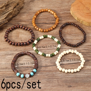 Set of 6 vintage wooden beaded bracelets with turquoise accents on a wooden background