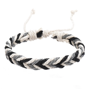 Close-up of black white and grey braided cord bracelet with adjustable drawstring knot