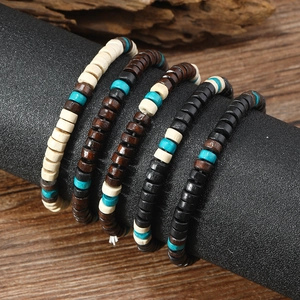 Ethnic handmade wooden bead bracelet set for men with turquoise accents on display