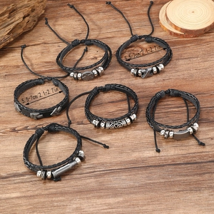 Detail of six-piece punk braided leather bracelets with star and arrow metal charms