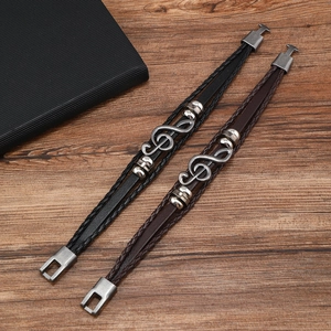 Braided leather bracelets in black and brown featuring silver treble clef music charms