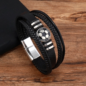 Detail of multi-layer black leather bracelet with soccer motif and silver magnetic clasp