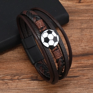 Detailed macro view of leather braided soccer bracelet with magnetic metal clasp on wood
