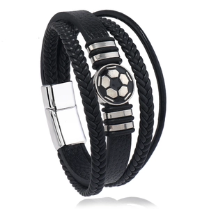 Detail of multi-layer leather bracelet featuring soccer emblem and silver magnetic clasp
