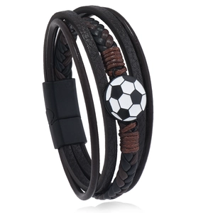 Detail of soccer charm on multi-layer braided leather bracelet with magnetic clasp
