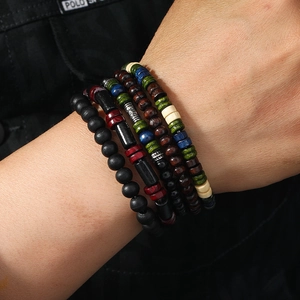Men's retro wooden bead bracelet set with four unique mixed styles on a male wrist