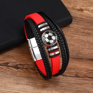 Detail shot of multi-layer leather bracelet featuring a metal soccer ball and magnetic clasp