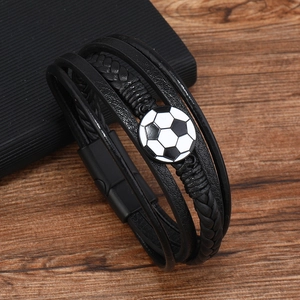 Detail of men's leather bracelet featuring a black and white soccer charm and magnetic clasp
