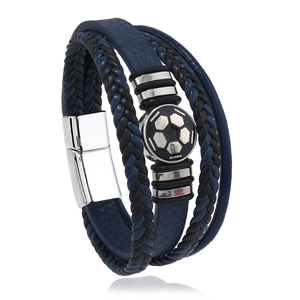 Detail of multi-layer leather bracelet with soccer pattern charm and magnetic clasp