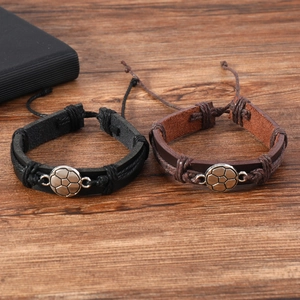 Retro football theme braided leather bracelets in black and brown on wood background