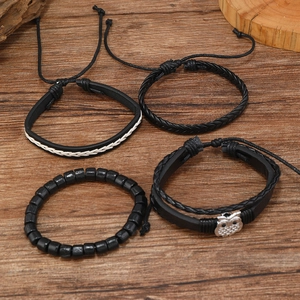 Mens vintage black leather owl charm bracelet set with woven beads on dark wood