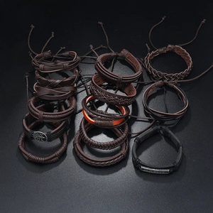 Detailed close-up of tree of life charms and Jesus engraving on men's leather bracelet set