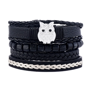 Layered black leather woven bracelet set featuring a silver owl charm and wooden beads