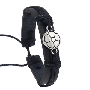 Detail of adjustable black leather bracelet featuring a silver metal soccer charm
