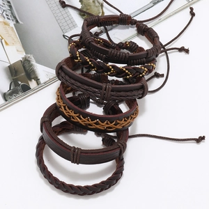 Close-up of multi-layer woven leather bracelets with metal beads and adjustable cords