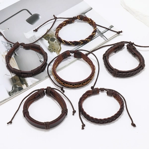 Detail of vintage brown braided leather bracelets set with adjustable drawstring knots