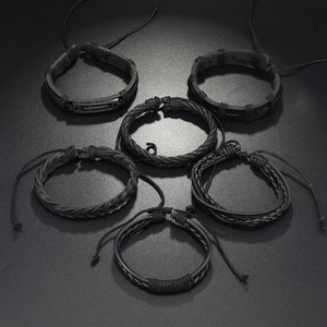 Detail view of 6-piece black leather and woven bracelets with metal cross charms