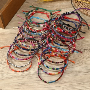 Close-up of colorful Bohemian braided bracelets with adjustable slide knot detail