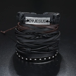 Macro detail of multi-layer leather bracelet featuring metal plate with I Heart Jesus engraving
