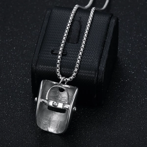 Polished silver stainless steel welding mask pendant on box chain over black jewelry box