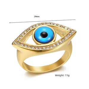 Detail view of gold-plated evil eye ring with blue stone and white crystals, 29mm width