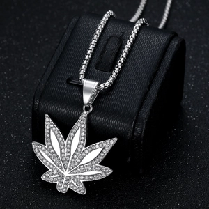 Pendentif feuille d'érable en argent avec cristaux sur support de luxe en cuir noir