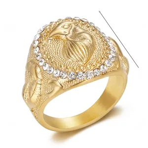 Macro shot of 22mm gold eagle ring for men with crystal halo and brushed finish details