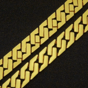 Macro close-up showing textured and smooth matte gold finishes on hip-hop Cuban link chains