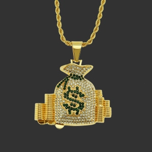 Close-up of golden money bag pendant with dollar sign and sparkling crystals detail