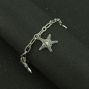 Silver marine style link bracelet featuring realistic textured starfish charms for women