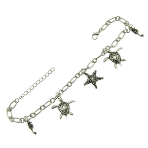 Marine themed silver charm bracelet featuring detailed turtle, starfish and seahorse pendants