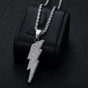 Sparkling iced out lightning bolt pendant with silver rope chain on black background