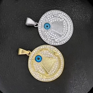 Macro detail of silver and gold Eye of Providence pendants with blue stones and crystals