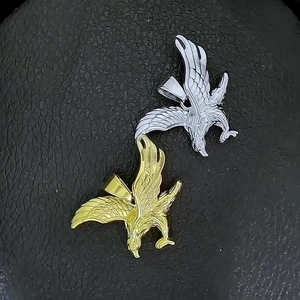 Detail of detailed eagle wings on 316L stainless steel gold and silver pendants
