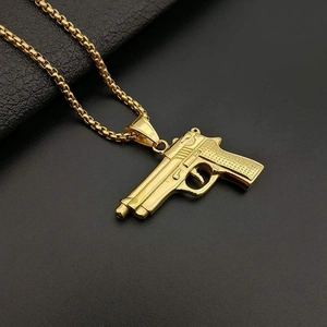 Golden M1911 pistol pendant necklace with box chain on black leather background