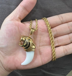 Gold tiger head pendant with claw accent on heavy rope chain necklace for men
