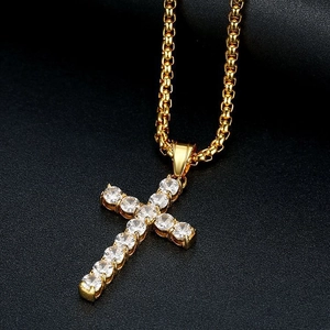 Macro view of gold-plated cross pendant featuring sparkling zircon micro-pave setting