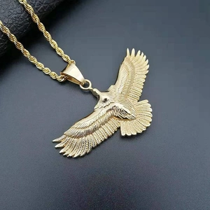 Polished golden eagle pendant necklace with intricate feather detail on a black rope chain
