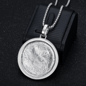 Detail showing vintage silver eagle necklace with rough lava texture and box chain link