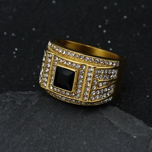 Iced out gold men's ring featuring a square black stone and encrusted white crystals