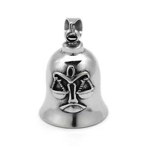 Detailed macro view of silver stainless steel bell pendant with Libra zodiac relief