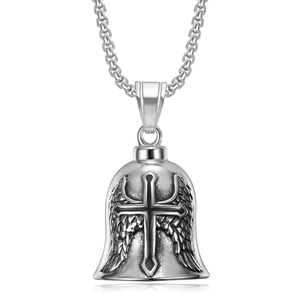 Detailed macro view of vintage biker pendant with bell shape, angel wings and cross