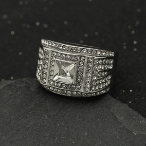 Macro view of men's wide stainless steel ring with square center gem and pavé diamonds