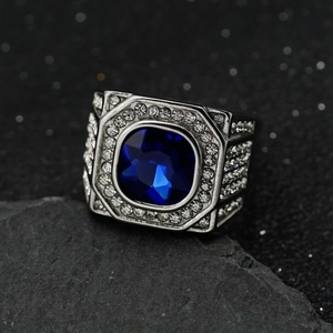 Macro detail of men's square blue gemstone ring with pave white diamonds on silver metal