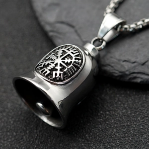 Vintage stainless steel Viking rune bell necklace on natural rock background