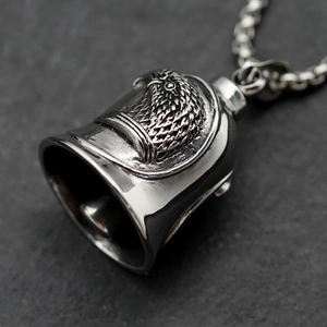 Punk eagle bell pendant necklace made of vintage stainless steel on stone background